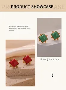 Detailed showcase of geometric gold-plated earrings with red and green natural stones