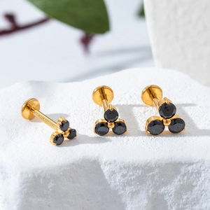 F136 titanium labret stud with three black zircons in a floral gold setting