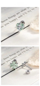 Macro detail of mint green heart and clover cartilage studs with screw flat backs