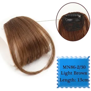 Detail view of light brown clip-in bangs showing breathable lace net and BB clips