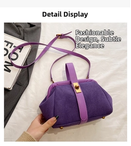 Detailed view of purple frosted leather bag with golden metal clasp on white fabric