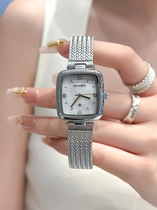 Detail of silver square watch with mother-of-pearl dial and woven mesh metal strap