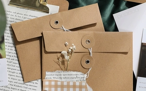 Macro detail of kraft paper envelope with round button and white string closure design