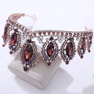 Macro shot of rose gold baroque bridal crown with purple crystals and white rhinestones