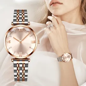 Detail of a two-tone steel watch featuring a champagne sunray dial and rhinestone markers