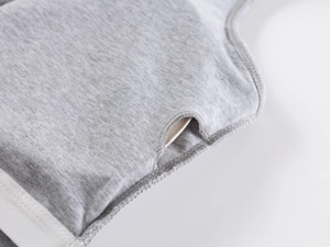 Detailed macro view of the removable chest pad slot on a grey ribbed sports tank top