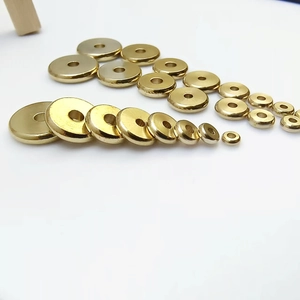Flat solid brass spacer beads in various sizes for DIY jewelry making on white background
