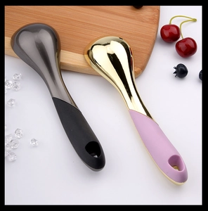Polished metal ice cream scoops in grey and gold with ergonomic handles on white background