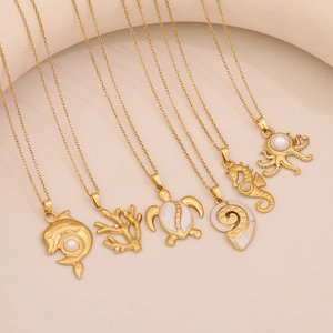 Golden stainless steel ocean theme necklaces with sea life pendants and pearl accents