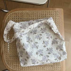 Close-up of lilac floral cotton shoulder bag with a small simple wish fabric label