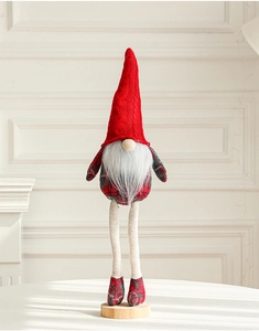 Detailed view of plush Christmas gnome with red knitted hat and wooden base for holiday decor
