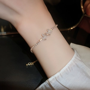 Close-up of golden marquise zircon bracelet with adjustable bead chain on wrist