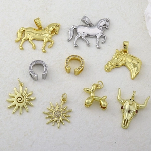 Detailed view of mixed gold and silver micro-set zircon charms in various animal shapes