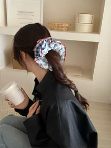 Blue and white plaid scrunchie with lace trim and cherry print on braided hair