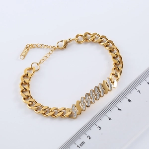 Gold cuban chain bracelet with diamond-set wave letters and lobster clasp