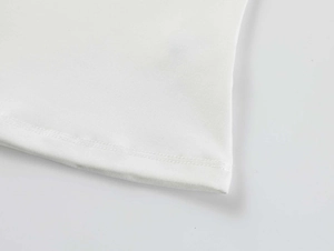 Close-up of white athletic t-shirt hem featuring durable double-needle stitching detail