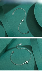 Detailed shot of S925 sterling silver cross bracelet with lobster clasp and extender chain