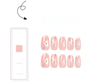 Detail of pink press-on nails featuring white starburst patterns and tiny rhinestones