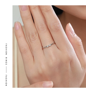 Detail of S925 silver bow ring featuring micro-pave crystals on a model hand