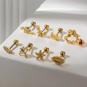 Set of 8 gold stainless steel helix studs with pink and clear crystals on a white display