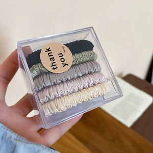 Close-up of 5-piece fabric hair scrunchie set in elegant earth tones and premium gift box