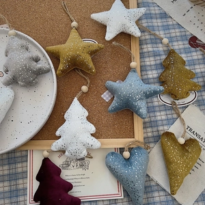 Close-up of handmade fabric Christmas ornaments with wooden beads and rustic jute twine