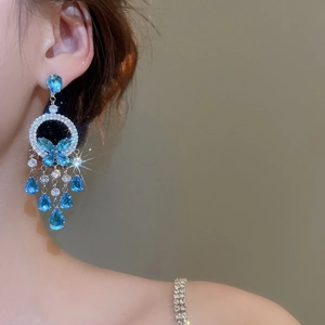 Detailed view of elegant blue butterfly tassel earrings with zircon and silver finish