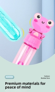 Macro shot of pink frog-shaped cartoon bubble sticks with transparent liquid tube