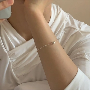 Close-up of S925 sterling silver bead bracelet with water drop charm on model wrist