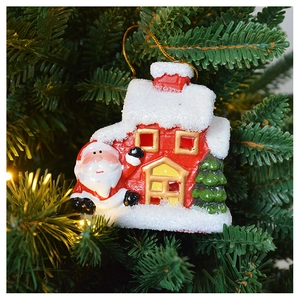 Detailed close-up of a festive red ceramic house ornament with snow on a Christmas tree