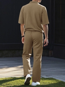 Detail shot of men's khaki seersucker textured short sleeve shirt and matching trousers set