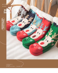 Detail of five pairs of thick fleece-lined Christmas socks with elk and snowflake patterns