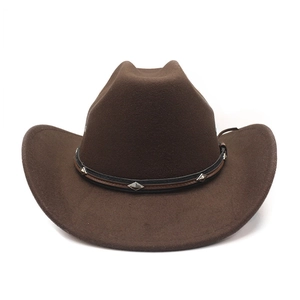 Detail of brown felt cowboy hat featuring two-tone leather band with silver metal rivets
