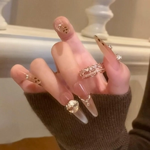 Close-up of zircon mother-of-pearl heart ring and leopard print press-on nails