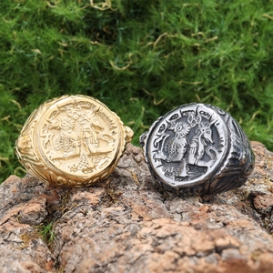 Macro shot of vintage gold and silver coin rings with 1913 relief on moss background