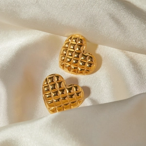 18k gold plated stainless steel heart earrings with quilted grid texture on white silk