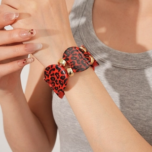 Detail of red leopard print oval links on stylish bracelet with gold hardware