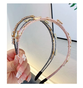 Detail of double-layer headbands with sparkling rhinestones and crystals in pink and grey
