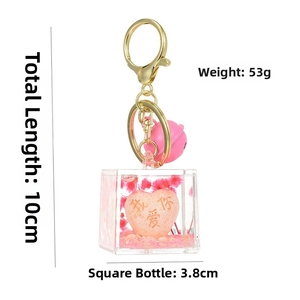 Detail of a pink heart liquid keychain with I Love You engraving and sizing metrics