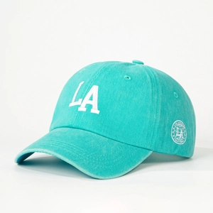 Detail of LA embroidery on washed cotton baseball cap in mint blue with side patch