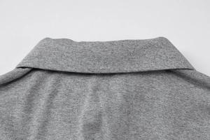 Detailed view of the soft grey knit texture and polo collar on this slim long sleeve top