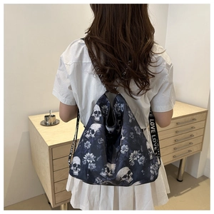 Detail of gothic drawstring backpack with skull floral print and LOVE lettered straps