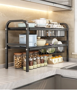 Detail of black double-tier kitchen sink rack with carbon steel shelves and basket