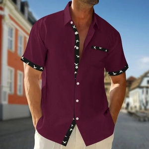Close-up of wine red waffle knit shirt featuring birds print trim and button closure