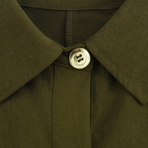Front view of olive green lapel dress with detailed twill fabric and gold button closure