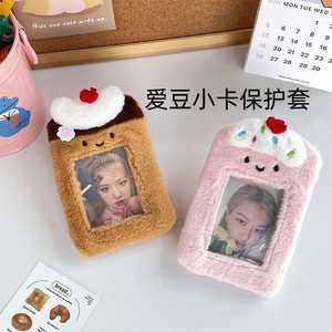 Cute plush cake idol card holders in brown and pink colors on a cozy tabletop