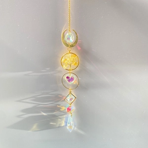 Detailed view of Tree of Life suncatcher with rainbow crystals and golden moon charm