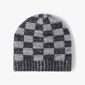 Winter knit beanie with black and white checkerboard pattern and ribbed cuff design