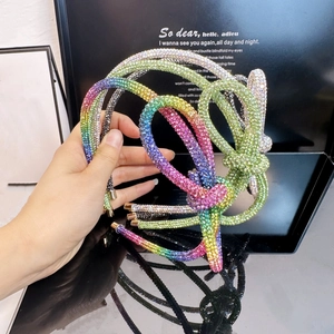 Close-up of a multi-layer rainbow rhinestone headband with a sparkling knotted design