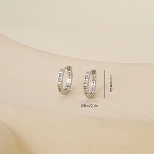 Detail view of silver cubic zirconia earrings with measurements 1.2cm height and 0.2cm width